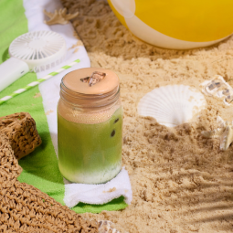 Iced chocolate pistachio matcha on beach