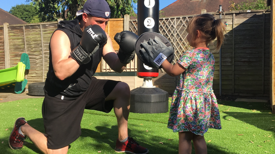father boxing with daughter