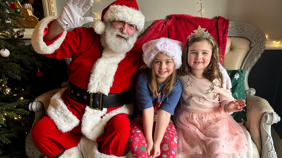 Children sitting with Santa