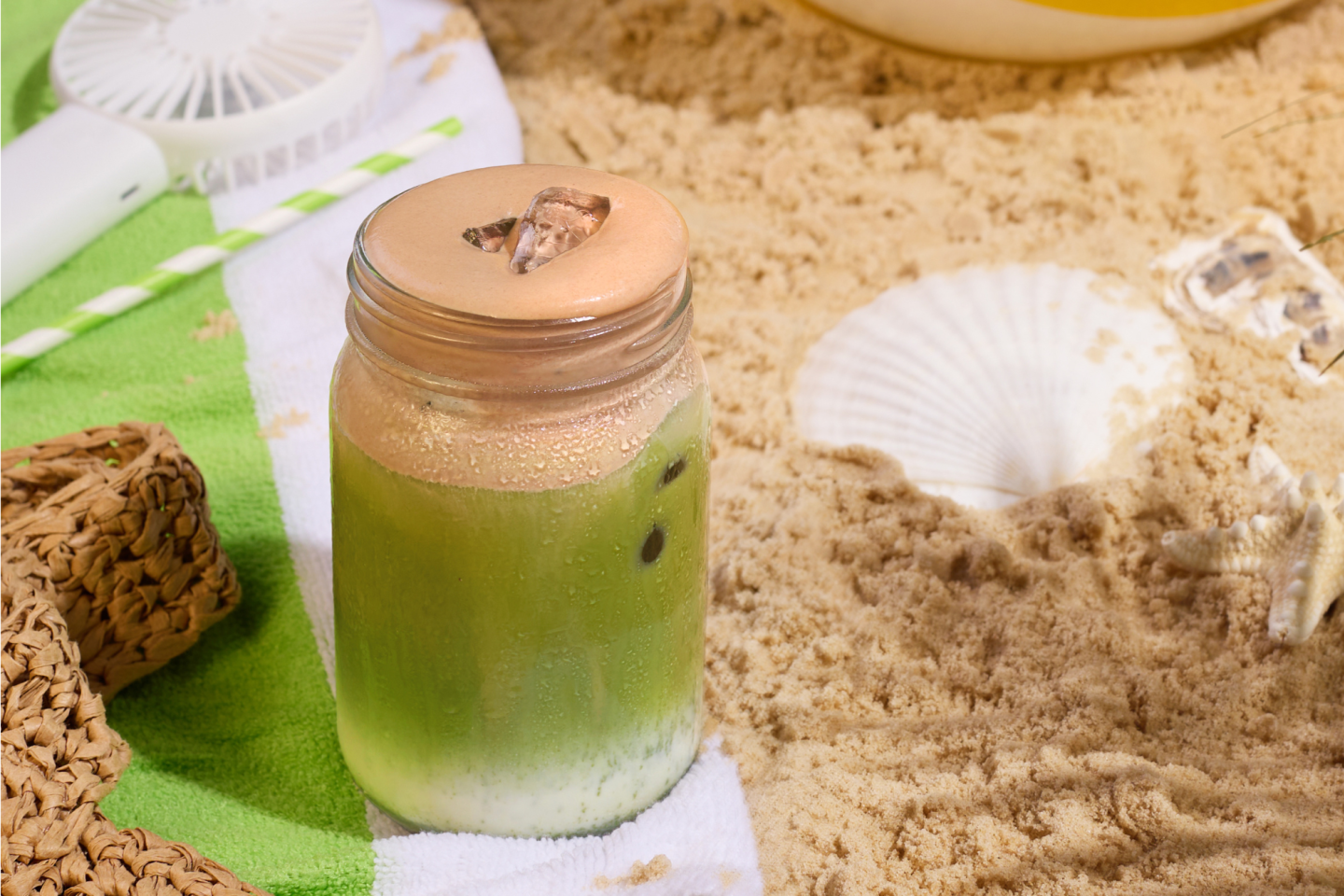 Iced chocolate pistachio matcha on beach Iced chocolate pistachio matcha on beach