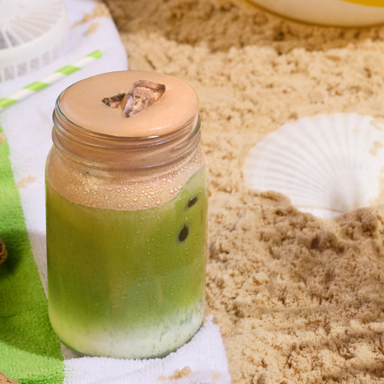 Iced chocolate pistachio matcha on beach Iced chocolate pistachio matcha on beach