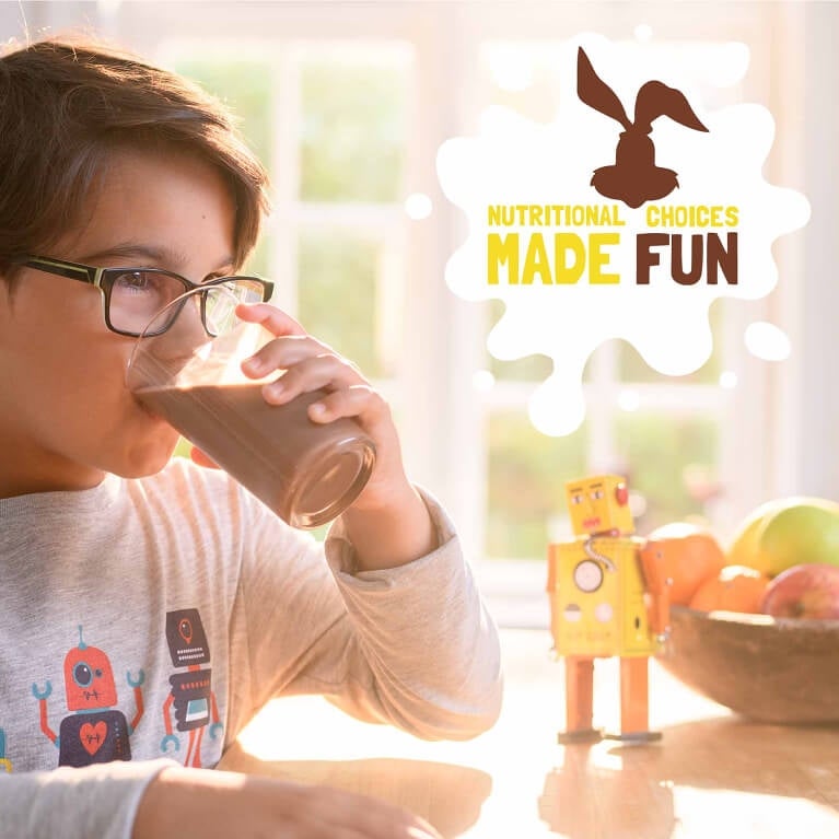 Young boy drinking a glass of Nesquik