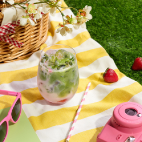 Iced Strawberry Matcha on picnic blanket